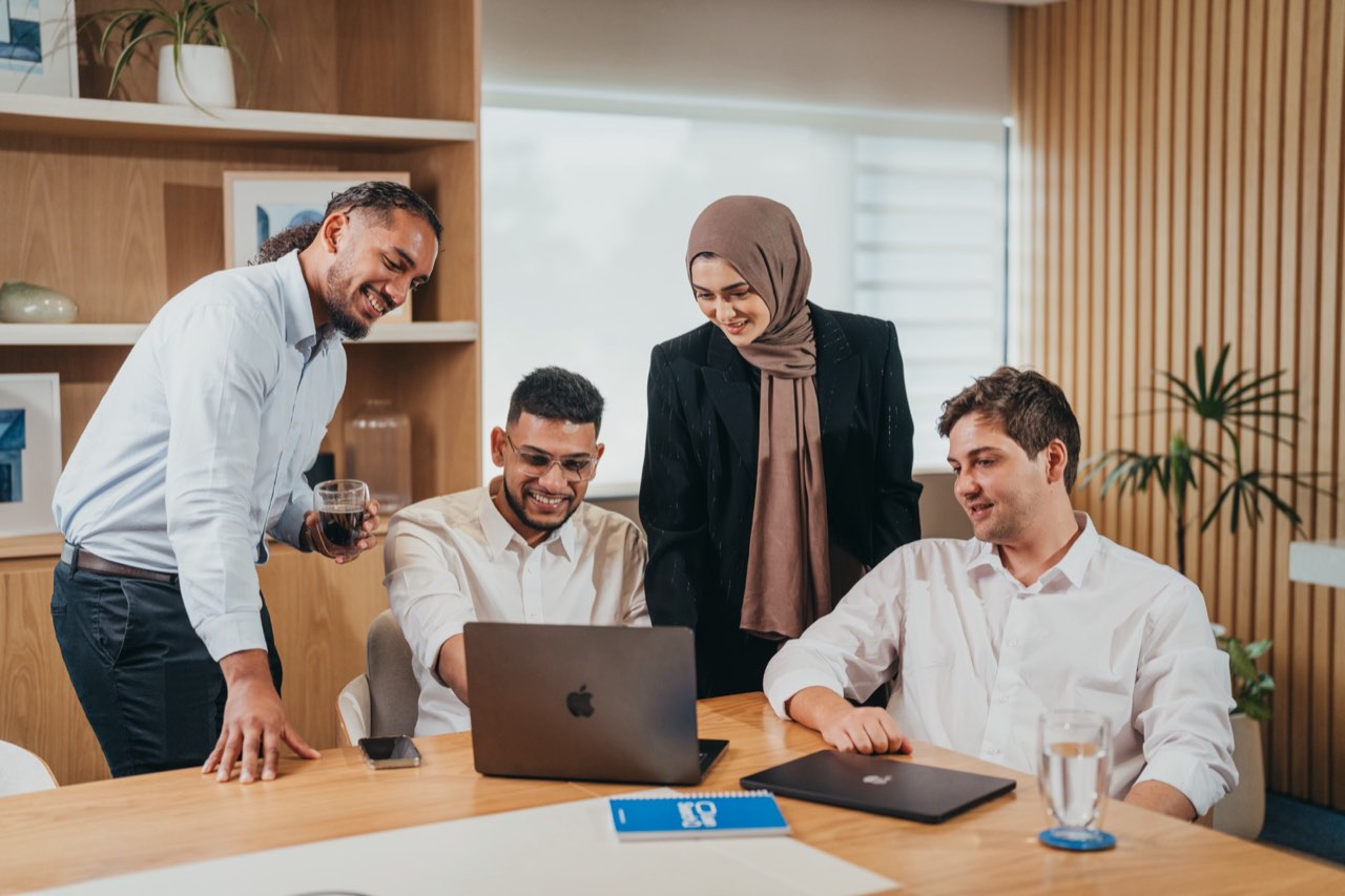 The Lean Search ads and creative team working around a laptop