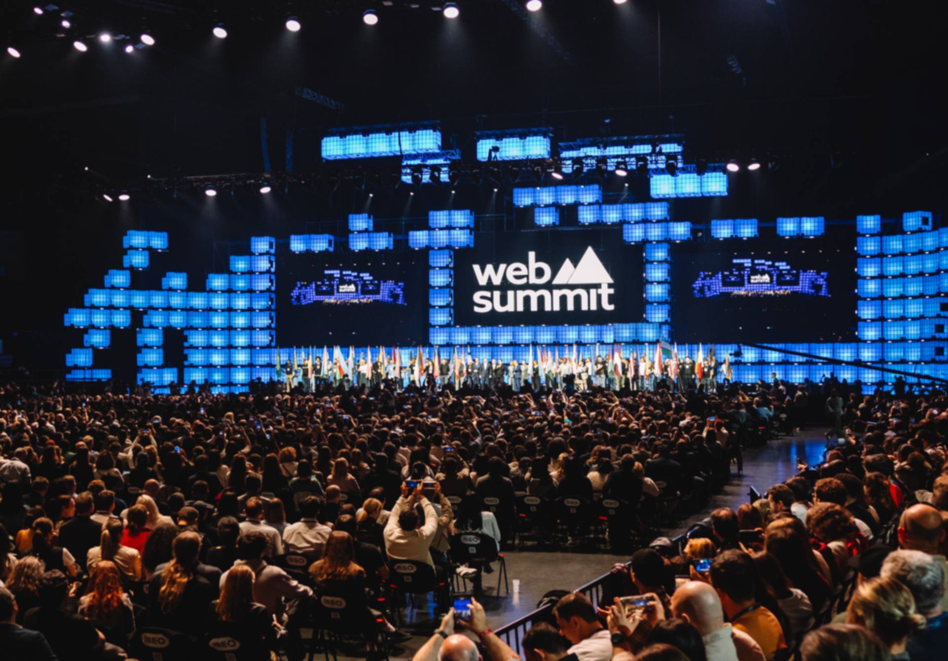 Opening Night of Web Summit on Centre Stage in Lisbon, flag bearers lined up in front of a full arena